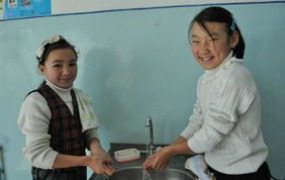 Girls practice hand washing as part of a hygiene education program in Kyrgyzstan